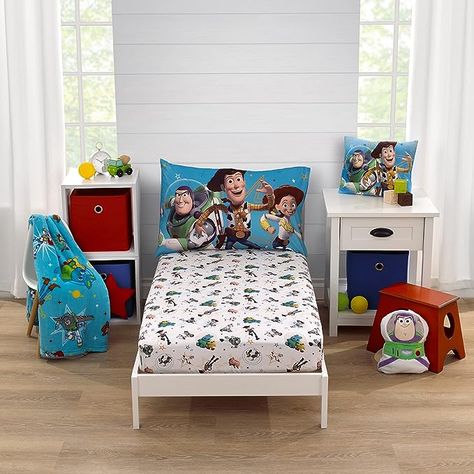 100% Polyester This 2-piece toddler sheet set includes a fitted bottom sheet and reversible pillowcase Features a playful pattern with Woody, Buzz Lightyear, and their friends! Designed in bright shades of blue, green, red, yellow, and white The sheet measures 28" x 52", and fits a standard size crib/toddler mattress Reversible pillowcase measures 20" x 30" and uses a standard size pillow Reversible Pillowcase, Toy Story Room, Soft Nursery, Toddler Sheets, Mini Crib Sheets, Toddler Mattress, Mini Crib, Toddler Blanket, Fitted Crib Sheet