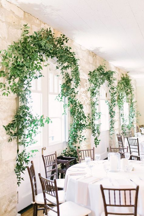 Stems Floral Design | Chateau Bellevue | Blue Moon Events | Kate Elizabeth Photography | | | ...Greenery in the Reception Area Smilax Inspiration Indoor Reception Stone Wall Light and Airy Wedding Greenery Over Doorway, Wedding Vines, Greenery Around Doorway Wedding, Ivy Wedding Decor, Smilax Vine, Smilax Wedding, Wedding Greenery Wall Lights, Wedding Backdrop Greenery Lights, Smilax Arch