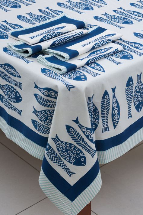 Our Fish Tablecloth is made with soft 100% cotton and is hand block printed by artisans in Rajasthan, India using hand carved wooden blocks. Great skill and precision is required for the artist to create these fine hand block prints, and the natural variations that occur with hand block printed textiles adds to the authentic beauty of each piece. These fair trade tablecloths can also be used as a twin bedspread and have matching napkin sets and table runners sold separately. Size: 60" x 90" Resist Printing, 6 Seater Dining Table, Twin Bedspreads, Block Printed Textiles, Authentic Beauty, Printed Napkins, Fish Patterns, Rajasthan India, Cotton Tablecloths