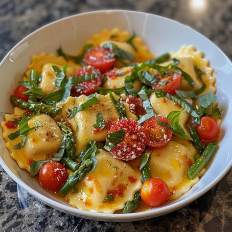 🌞🍝 Bask in the flavors of summer with this light, garden-fresh pasta dish! #SunKissedRavioli #FreshPasta 🍽️ Sun-Kissed Ravioli with Tomato, Asparagus, and Herbs 🛒 Ingredients: 500 grams fresh ravioli 200 grams cherry tomatoes, halved 150 grams asparagus, trimmed and cut into pieces 50 grams fresh basil, chopped 30 grams parmesan cheese, grated 2 cloves garlic, minced (10 grams) 2 tablespoons olive oil (30 ml) Salt and pepper to taste 👩‍🍳 Instructions: Cook Ravioli: Boil ravioli according ... Trending Recipes, Fresh Pasta, Fresh Basil, Ravioli, Cherry Tomatoes, Basil, Tasty Dishes, Asparagus, Pasta Dishes