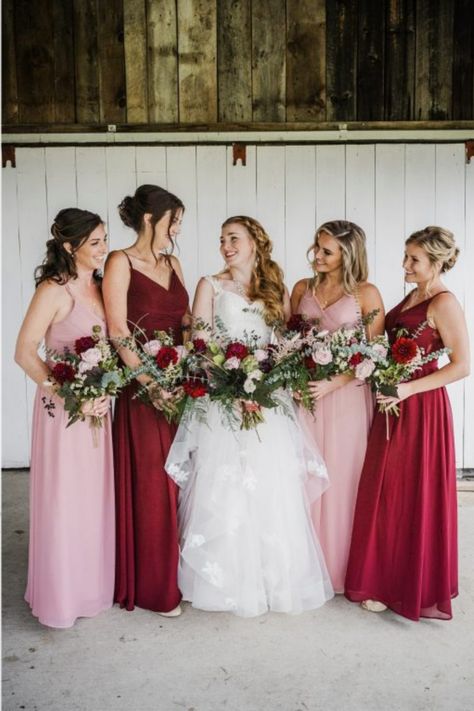 Bridesmaids wearing red and pink dresses in a rustic fall wedding. Red And Pink Rustic Wedding, Magenta Pink Wedding Theme, Pink Red And White Wedding Bridesmaid Dresses, Red And Pink Wedding Bridesmaid Dresses, Pink Red Burgundy Wedding, Deep Red And Pink Wedding, Red And Blush Bridesmaid Dresses, Red And Pink Wedding Party, Pink And Red Wedding Groomsmen