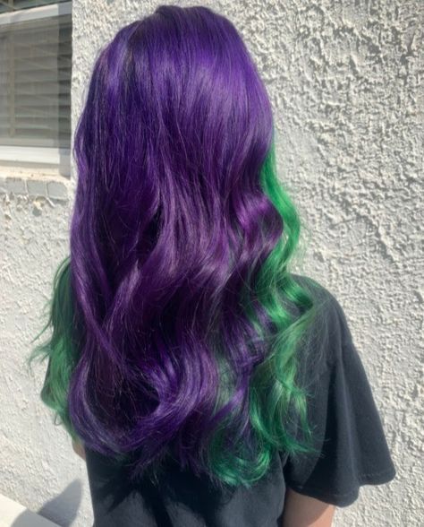 Purple and green created by Stylist Angi! Call 410-795-9465 to reserve today. Green And Purple Peekaboo Hair, Purple And Green Money Piece Hair, Purple Hair Green Money Piece, Purple With Green Hair, Purple Hair Green Highlights, Green Roots Purple Hair, Purple And Green Hair Color, Purple Hair With Green Highlights, Purple Green Hair Color