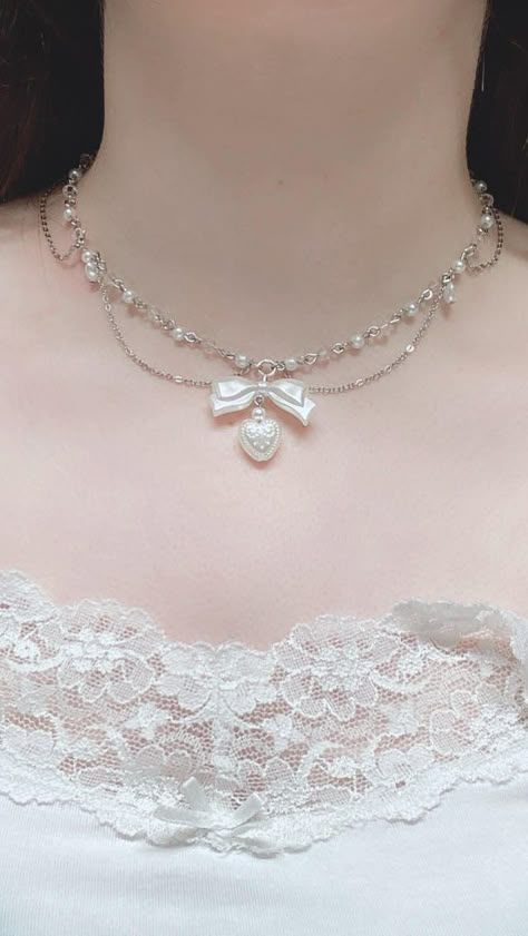 Presenting our Coquette Pearl Necklace with Bow & Hearts - the epitome of princess charm and elegance! This layered bead necklace exudes playful sophistication with its delicate pearls and charming bow and heart accents. Crafted with meticulous attention to detail, this princess jewelry piece is perfect for adding a touch of whimsy to any outfit. Elevate your style with this enchanting necklace and channel your inner princess effortlessly. Order now for a regal touch of elegance and undeniable c Cute Necklaces Pearl, Coquette Assesories, Pearl Bead Jewelry, Jewelry Princess, Jewelry White, Princess Core Accessories, Cute Aesthetic Jewelry, Pearls Fashion, Necklace Elegant