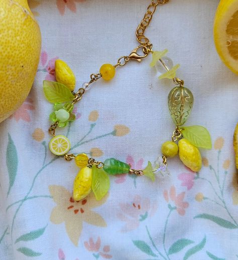 🍋 Lemon Meringue bracelet 🍋 . . ☆ lemon charms made with polymer clay ☆ features lampwork glass bead, other flower glass beads, and polymer clay lemon slice bead . . . #handmade #beadedaccessories #beadings #strawberryshortcake #accessories #polymerclay #lemonmeringue #lemons #yellow #y2k Polymer Clay Lemon, Lemon Bracelet, Yellow Y2k, Lemon Slice, Lemon Meringue, Beaded Accessories, Lampwork Glass Beads, Strawberry Shortcake, Jewelry Projects