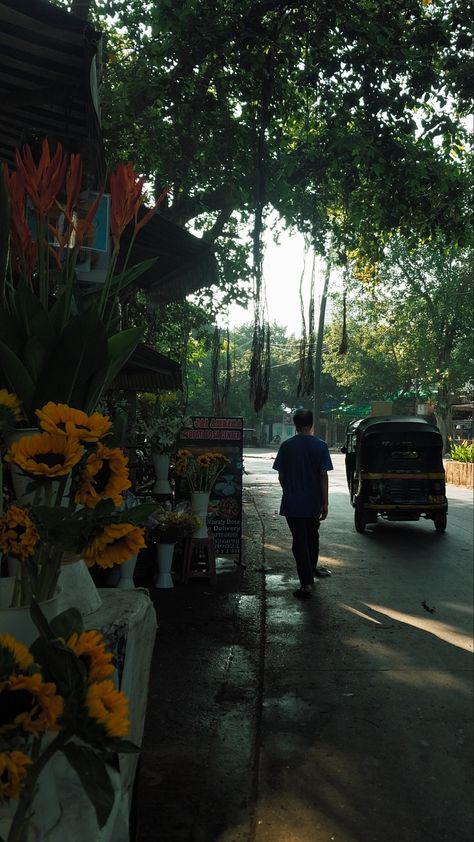 Sunflowers stuck in a flower shop while sun is shining on the end of the road Delhi Morning Snap, India Asethic, Aesthetic Pictures Indian, Asthetic Mornings, Rainy Sky, City Life Photography, Beach At Night, India Photography, App Pictures