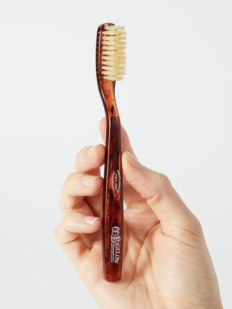 A C.O. Bigelow toothbrush designed with natural boar bristles and a tortoiseshell pattern that look like something out of a Sherlock Holmes film. We love mundane products that look luxe 👏 and 👏 vintage 👏. Co Bigelow, C.o. Bigelow, Toothbrush Design, Bite Beauty, Makeup Mirror With Lights, Teeth Care, Light Makeup, Carrying Case, The Natural