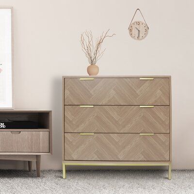 The natural oak dressers creates a truly vintage and unique piece of accent furniture. The three-drawer chest is completed with symmetrical herringbone pattern drawer and classic gold metal handle that perfectly outline the rich tones in the wood and add a luxurious look and taste to the overall design. | Corrigan Studio® Bendt 3 Drawer 15.75" W Dresser Wood in Brown, Size 29.53 H x 15.75 W x 31.5 D in | Wayfair Dresser Mid Century, Organizer Bedroom, Bedroom Storage Cabinets, Three Drawer Dresser, Oak Chest Of Drawers, Accent Storage Cabinet, Three Drawer Chest, Oak Dresser, Mid Century Dresser