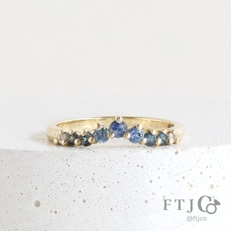 Making all your sapphire wedding band dreams come true with this one..! This stunning Diadem Band features a gorgeous array of Australian and Montana sapphires. Its gentle peak is elegant when worn alone and perfect for pairing with a wide range of our traditional and low-set engagement rings; swipe to see it with a cute lil' pear diamond solitaire! 😍💎🔵🟢 . This is a one-of-a-kind Sapphire Diadem Band made in 18K AKARA People+Planet Yellow Gold. It's set with two 1.5 mm White Chatham Lab Grow Colour Zoning, Colored Wedding Bands, Blue Sapphire Wedding Band, Montana Sapphires, Light Blue Sapphire, Sapphire Wedding Band, Montana Sapphire, Greenish Blue, Bluish Green