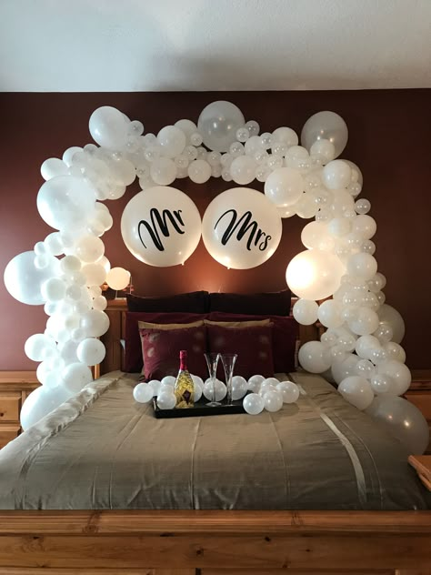 His and hers wedding balloon decorations are gorgeous even after the reception! Use creative balloon arch decorations for something unique, like your honeymoon bed. Complete with mini balloons with no helium for extra pop! Wedding Hotel Room, Mr And Mrs Balloons, Bridal Suite Decor, Honeymoon Rooms, Bridal Room Decor, Hotel Room Decoration, Romantic Hotel Rooms, Wedding Night Room Decorations, Romantic Room Surprise