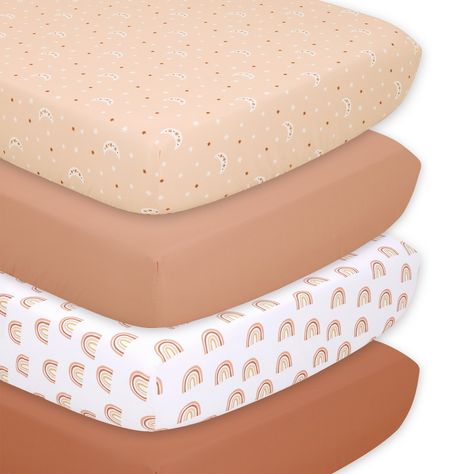 Introduce a touch of bohemian charm to your little one's nursery with the 4-pack Boho fitted crib sheet set by The Peanutshell. These soft and cozy sheets are designed to fit standard 28" x 52" crib mattresses perfectly, ensuring a snug and secure fit with their all-around elastic. Each sheet showcases a palette of warm earth tones; dusty coral, peach and tawny brown. From rustic rainbows to relaxing celestial prints paired with neutral solids, each sheet is a delightful tapestry of captivating Nursery Bedding Girl, Bohemian Rainbow Nursery, Burnt Orange And Pink Nursery, Terracotta Nursery Girl, Rainbow Baby Room, Boho Sunshine Nursery, Baby Girl Nursery Boho, Boho Girl Nursery, Terracotta Nursery