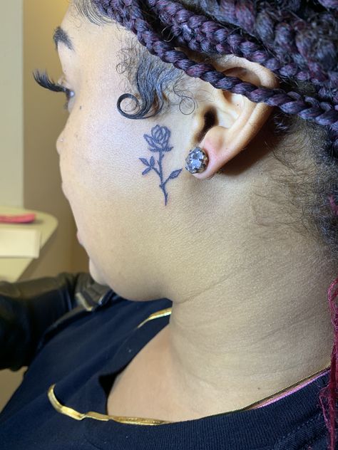 Small rose face tattoo Small Face Tattoos Black Women, Side Of Face Tattoo Black Women, Side Of Ear Face Tattoo, Rose On Side Of Face Tattoo, Small Rose Tattoo On Neck, Heart Tattoo On Side Of Face, Small Side Burn Tattoos For Women, Rose Sideburn Tattoo, Rose On Face Tattoo