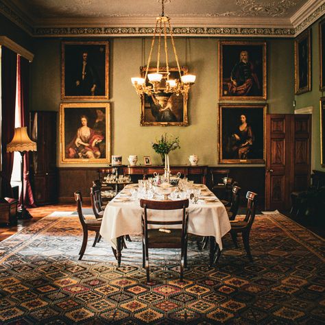 The dining room at Killerton House, Broadclyst was initially known as the Great Parlour and was elaborately decorated. This then became a library in the 19th century, complete with a hidden room. Sadly, the secret room has since been dismantled, but it’s mentioned in a contemporary account: ‘connected with this room is a private library and sitting-room, the entrance to which is through a bookcase, forming a hidden entrance.’ Then, this room was turned into the Aclands’ dining room during t... Old Mansions Interior Dining Rooms, Dark Academia Dining Room, Dining Hall Dark Academia, 18th Century Drawing Room, Hidden Entrance, Victorian Sitting Room, Victorian Dining Room, Castle Dining Hall Aesthetic, Kitchen Sitting Area