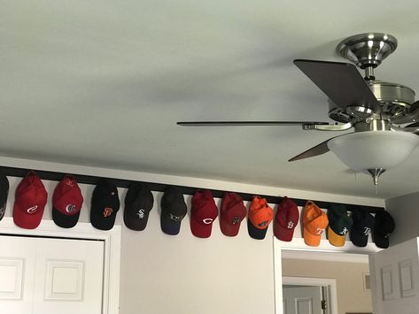 Great way to display the hats.  Very simple project! Pegboard Hat Rack, How To Display Ball Caps, Hat Memorial Display, Hat Shelves Ideas, Baseball Hat Displays, Organize Hats On Wall, Hang Baseball Hats On Wall, Baseball Hat Collection Display, Ball Cap Wall Display