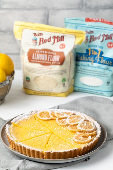 The tangiest Lemon Tart with a buttery gluten-free crust and tart lemon curd filling. This recipe reminds me of the classic French dessert - Tarte au Citron. #ad #betterwithbobs Candied Lemon Slices, Gluten Free Lemon Bars, French Tart, Lemon Tart Recipe, Classic French Desserts, Lemon Curd Filling, French Desserts, Lemon Tart, Gf Desserts