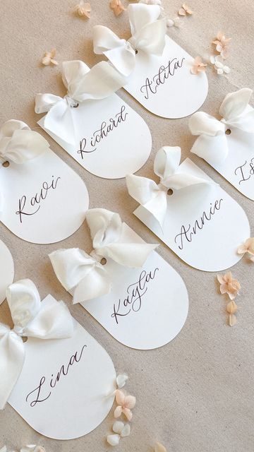 Frankie H | Wedding Signage & Stationery on Instagram: "Cutie little arched matte place cards with silk ribbon bows ✨ Ribbon from @cfleursdesign #placecards #weddingplacesetting #weddingplacecards #weddingbow" Wedding Seating Place Cards, Bow Name Cards, Bow Place Cards, Ribbon Place Cards, Wedding Place Card Ideas, Wedding Bridal Table, Place Card Ideas, Wedding Table Name Cards, Calligraphy Place Cards