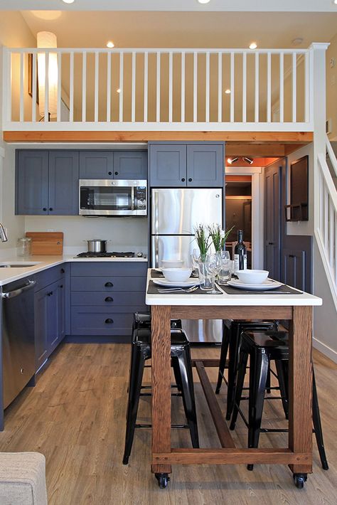 The L-shaped kitchen includes a rolling island/dining table that was custom built for the space, a cooktop, refrigerator, and dishwasher. Design Casa Piccola, Cottage Tiny House, Tiny House Towns, Small Tiny House, Tiny House Interior Design, Rolling Kitchen Island, Tiny House Layout, L Shaped Kitchen, Tiny House Kitchen