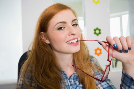 Happy redhead biting her reading glasses... | Premium Photo #Freepik #photo #house #red #hair #happy Biting Glasses Pose, Glasses Pose, Hugging Couple, Office Holiday Party, Girl Sleeping, Rich Women, Office Holiday, Moving Day, Woman Standing