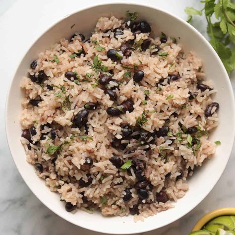 This easy and quick rice cooker black beans and rice recipe is a great way to add variety and flavor to any meal! This recipe is inspired by Cuban black beans and rice, with hints of garlic, oregano and cumin, and finished with a squeeze of lime and sprinkle of cilantro. It goes great with your choice of protein and veggies. Rice Cooker Coconut Rice, Cuban Black Beans And Rice, Black Beans And Rice Recipe, Rice And Black Beans, Quick Rice, Cuban Black Beans, Dried Black Beans, Black Beans And Rice, Mushroom Rice