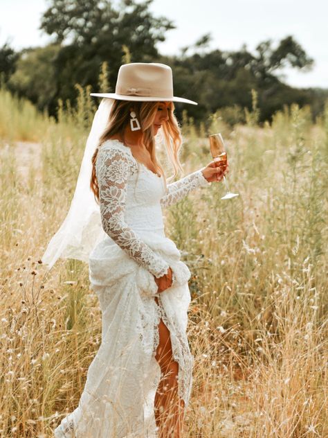 Hat With Wedding Dress, Brides Wearing Hats, Wedding Dress With Cowboy Hat, Wedding Dresses With Hats, Western Wedding Hat, Wedding Dresses And Cowboy Boots, Boots With Wedding Dress Boho, Cowgirl Hat With Wedding Dress, Long Sleeve Wedding Dress Hairstyle