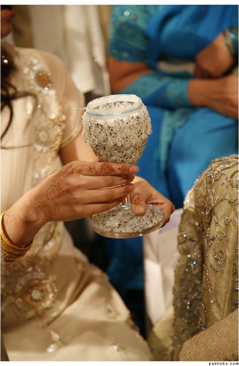 In Pakistan a beautiful glass of milk is offered to the groom which is a centuries old tradition that still takes place today. The milk is traditionally given by the brides sisters. After the groom gives the sisters an offering they will give him the milk. They say the person who drinks the rest of the milk in the cup will ought to get married soon. Much like the flowers in a traditional Christian wedding. Brides Mate, Pakistani Wedding Decor, Wedding Diary, Bridal Gift Wrapping Ideas, Desi Wedding Decor, Wedding Gifts Packaging, Rustic Wedding Diy, Wedding Entrance, Brown Wedding