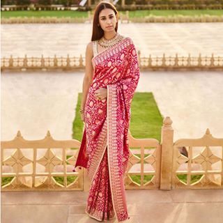 Handwoven at the holy shores of River Ganga, Benarasi weaves were transformed into the ‘garments of Gods’. Embroidered with sequins, dori, zari interlaced with our signature gota patti, the pink Kahana Saree is dressed in the traditions of Benaras. Location courtesy: @suryagarh . . . #anitadongre #anitadongrecouture #anitadongrefinejewellery #diaryofarajkumari #sisterhood #bestfriend #bridalcouture #indianfashion #benarasi #brocade #nyc Anita Dongre Saree, Indian Wedding Outfit, Anita Dongre, Embellished Blouse, Elegant Saree, Stylish Sarees, Indian Wedding Outfits, Indian Attire, Saree Dress