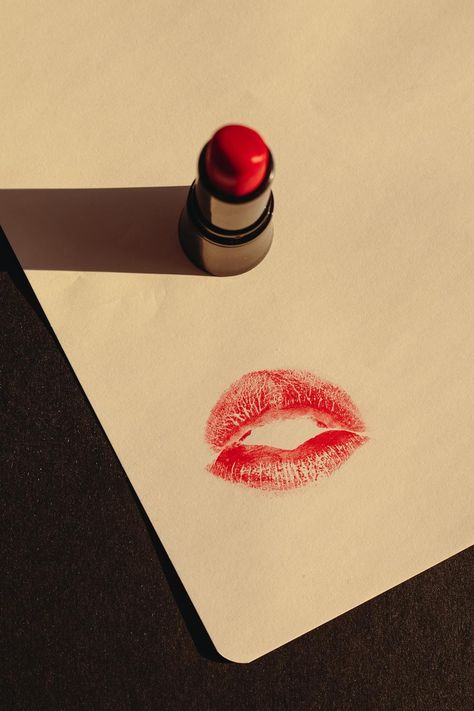 A Red Lipstick and a Print of a Kiss on Paper · Free Stock Photo Lipstick Swatches On Paper, Lipstick Marks On Paper, Kiss On Paper, Kiss Paper, Lipstick Photography, Lipstick Aesthetic, Red Lipstick Kisses, Lipstick Smudge, Lipstick Print