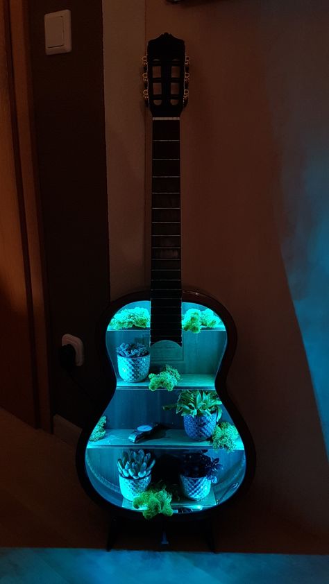 I built a shelf from my old guitar with a led strip and some plants Diy Guitar Shelf, Old Guitar Repurpose, Guitar Shelves, Guitar Lamp, Guitar Decor, Guitar Decorations, Guitar Shelf, Guitar Light, Old Guitar