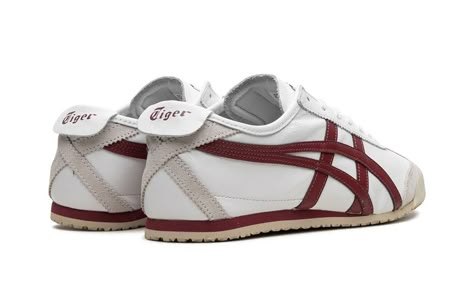 The Onitsuka Tiger Mexico ‘66 “White/Burgundy” is an eye-pleasing colorway of the retro sneaker by the Japanese footwear brand.  The Onitsuka Tiger Mexico ‘66 was originally a performance running shoe that debuted in 1966 during the trials for the Mexico City summer olympics in 1968, and through the years it has become a popular casual shoe.  The modern iteration of the model is largely similar to the original edition, but is made with contemporary materials and colors.  Here, “White/Burgundy” colorway has a white leather construction with burgundy tiger stripes on the sides.  “Onitsuka Tiger” branding is found on the tongue tag.  A vintage-inspired, thin cream foam midsole and rubber outsole complete the sleek design. Onitsuka Tiger White, Japanese Sneakers, Japanese Shoes, Onitsuka Tiger Women Outfit, Onitsuka Tiger Women, Luxury Paper Bag, Tiger Mexico 66, Onitsuka Tiger Mexico 66, Punk Style Outfits