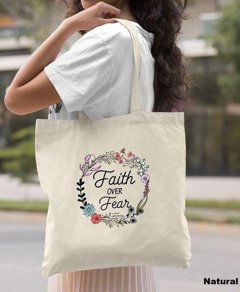 "Faith Over Fear Tote Bag, Christian Bag for Women, Christian Tote Bag, Women Christian Gift, Christian Canvas Bag, Religious Gift HOW TO ORDER: 1. Please, Check and Review all Photos. 2. Select Your Bag Style and Color from drop down menu. 3. Choose Your Quantity as much as you want. 4. Click \"Add To Cart\". For multiple items go back to the listing and repeat the steps. *DETAILS OF THE BAGS: Regular Tote Bag Measurements - 15\"L x 16\"H Tri Color 11L Toe Bag Measurements - 15\"L x 15\"H x 3\"D 100% cotton. 20\" self-fabric handle. 9\" handle drop * PROCESSING & SHIPPING: Processing is 1-2 days. First Class Shipping is 2-5 business days (after processing time). **SHIPPING UPGRADE: You can upgrade your shipping on the checkout page. We offer UPS Ground (2-4 Business Days) and UPS Air (2 B Bible Tote Bag, 1 Peter 2 9, Diy Lettering, Tote Bag Christian, Baby Shower Party Gifts, Bag Painting, Christian Tote Bags, Scripture Gift, Church Gifts