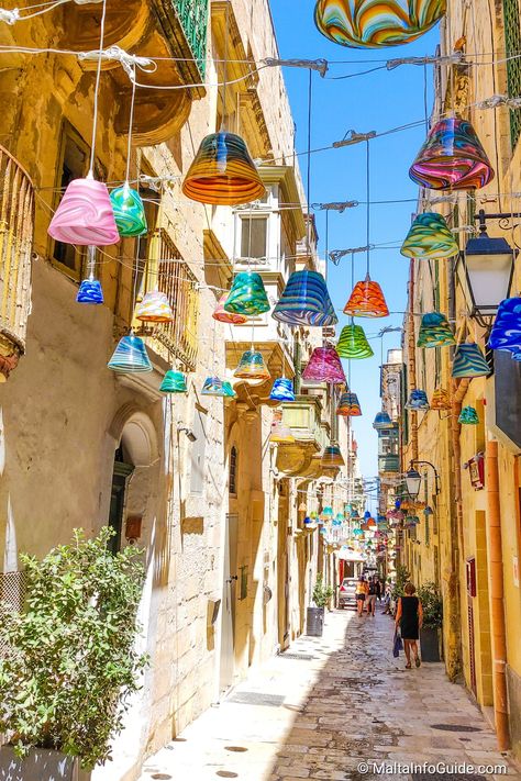 A narrow street in Valletta decorated with lanterns. Malta Italy, Malta Holiday, Malta Beaches, Malta Valletta, Mediterranean Travel, Valletta Malta, Malta Gozo, Malta Travel, Europe Holidays