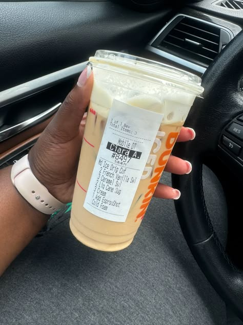 A hand holding a Dunkin’ cup with iced coffee flavored with French Vanilla and caramel, pictured inside a car Dunkin’ Donuts Drink, Dunkin Donuts Iced Coffee Order, Coffe Drinks, Dunkin Donuts Iced Coffee Orders, Dunkin Donuts Coffee Drinks, Dunkin Drinks, Dunkin Iced Coffee, Coffee Orders, Donuts Recipes