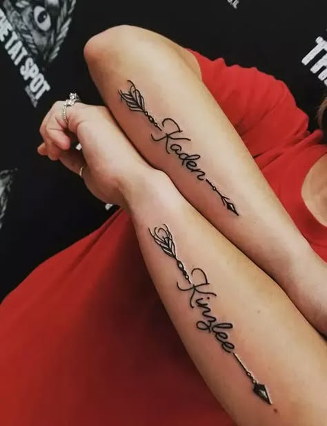 Arm Tattoos For Women Sons Name, Name Tattoo Feminine, Name Tattoos With Arrows, Flower With 2 Name Tattoo, Name Shoulder Tattoos For Women, Arrow With Name Tattoo Design, Name Tattoo Forearm Woman, Couples Names Tattoos, Men’s Name Tattoos