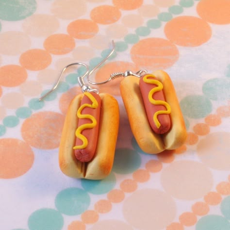 Handmade hot dog charms - with American style mustard. Yum! But in miniature, of course. Made individually, hand crafted from polymer clay. Delicate, yet bold! Each earring is 3cm long approx. Hung on 925 silver ear wires. Stand out from the crowd with these novelty earrings! Please check our other listings to find the matching hot dog necklace. Postage to the UK is free. Worldwide postage varies. Please check our policies for more information. Follow @feelmorelove on social media for more! Silly Earrings, Crazy Earrings, Weird Jewelry, Novelty Earrings, Diy Earrings Polymer Clay, Cute Miniature, Handmade Clay Jewelry, Polymer Earrings, Food Earrings