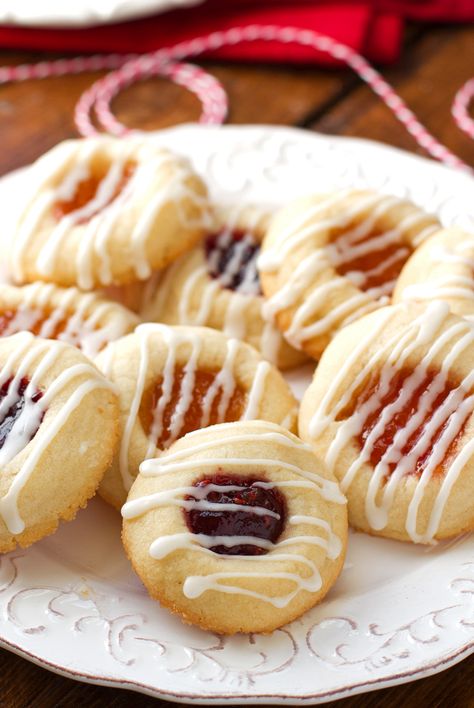 Easy 6 ingredient iced thumbprint cookies loaded with apricot or raspberry jam or jelly. Thimble cookies require little work. Shortbread cookie with jam. Thimble Cookies, Iced Thumbprint Cookies, Thumbprint Cookies With Icing, Raspberry Thumbprint, Raspberry Thumbprint Cookies, Jam Thumbprint Cookies, Thumbprint Cookies Recipe, Buttery Shortbread Cookies, Jam Cookies