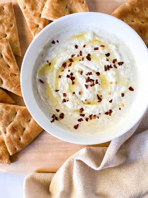 Disclosure: This post may contain affiliate links.This Roasted Garlic Whipped Feta Dip is seriously good! Paired with toasted pita wedges or pita chips, this easy appetizer is sure to be a crowd-pleaser. It is a delectable spread for sandwiches and burgers too. This dip is ready in just 30 minutes, thanks in part to the trusty blender!Find this recipe and more on my blog HERE: https://sugarylogic.com/roasted-garlic-whipped-feta-dip/ Whipped feta has become a popular topping and dip.… Garlic Whipped Feta, Garlic Feta Dip, Homemade French Onion Dip, Whipped Feta Dip, Roasted Red Pepper Soup, Full Fat Yogurt, Lemon Yogurt, Feta Dip, Delicious Appetizer Recipes