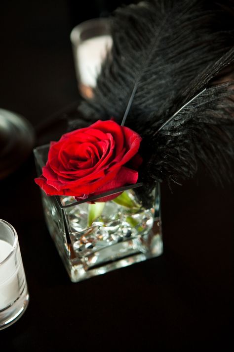 Love it! Black And Red Table Centerpieces, Rose And Feather Centerpiece, Red Black And Gold Wedding Centerpieces, Black Red Gold Centerpieces, Red And Black Flower Centerpieces, Black White Red Gold Party Centerpieces, Red Feather Centerpieces, Black And Red Roses Party Decor, Cabaret Centerpieces