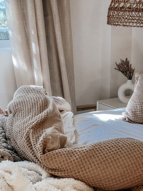 Neutral layered undone bed with morning light. ☕️☁️🤎 Layered Bedroom, West Coast House, Waffle Duvet Cover, Donut Vase, Cable Knit Throw Blanket, Rattan Light, Curtains White, Coast House, Cooling Sheets