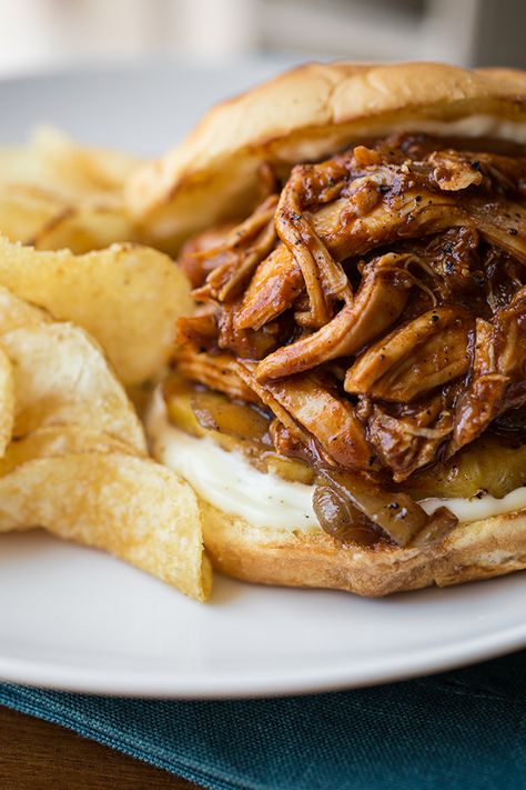 This pulled chicken sandwich with a zesty-smoky sauce is piled up with grilled pineapple and Maui onions, all on a soft Hawaiian bun! | thecozyapron.com #pulledchickensandwich #pulledchickensandwiches #pulledchickensandwichrecipes #pulledchickensandwichesstovetop Chicken Stovetop, Hawaiian Sandwiches, Pulled Bbq Chicken, Bbq Pulled Chicken Sandwiches, Hawaiian Buns, Pulled Chicken Sandwiches, Bbq Chicken Sandwich, Hawaiian Bbq, Chicken Sandwiches