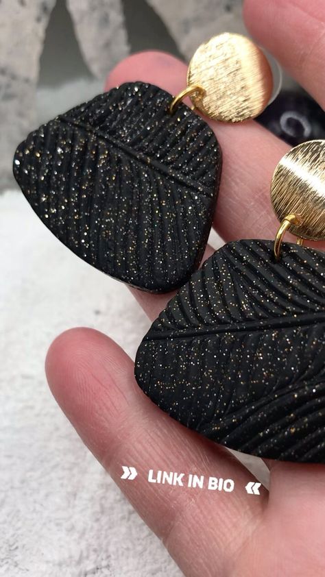 tinkeringtstrinketshoppe on Instagram: All that gold glitter! Check out these black polymer clay earrings with palm leaf texture in my Etsy shop. #glitter… Polymer Clay With Gold Leaf, Elegant Black Polymer Clay Jewelry, Gold Leaf Polymer Clay, Black And Gold Polymer Clay Earrings, Gold Leaf Polymer Clay Earrings, Black Polymer Clay Earrings, Xmas Earrings, Textured Clay, Black Polymer Clay