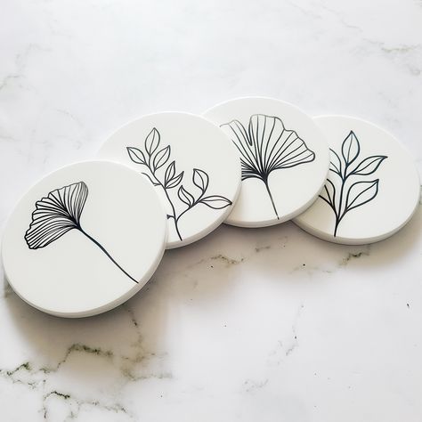 This Minimalist Coaster Set is designed to elevate your home decor. Its sleek and modern design add a touch of sophistication to any tabletop. The set has a clean and crisp look that suits any interior aesthetic. Crafted from high-quality materials, this coaster set is designed to stand the test of time. The minimalist style of each coaster gives you the perfect accent to any table setting. Comes in a set of 4 -Durable -Cork backing -Waterproof -Minimalist Design If you have any questions, feel free to message me and I'd be happy to answer them. Creative Coaster Design, Unique Coaster Designs, Designs For Coasters, Diy Coaster Designs Ideas, Sgraffito Coasters, Diy Painted Coasters, Painted Wooden Coasters, Diy Pottery Painting Ideas Simple, Coaster Art Ideas