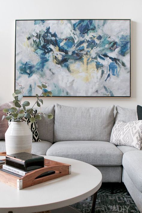 A blue and neutral piece of art over the couch. Love this large modern art hung over a gray sectional in the family room #art Art Over Couch, Family Room Art, Brown And Blue Living Room, Blue Walls Living Room, Large Modern Art, Brown Living Room Decor, Gray Sectional, Over The Couch, Above Couch