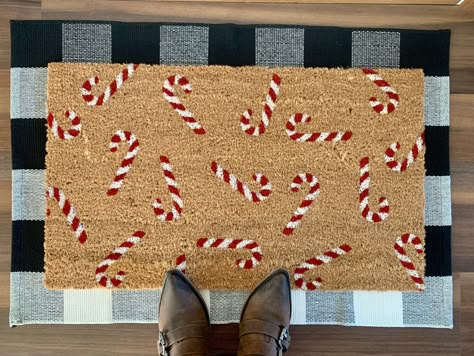 "Welcome holiday guests with this unique and festive candy cane door mat.  Door mats are hand painted with outdoor-rated paint. These coir door mats measure approximately 18\"x30\" in size and have non-slip backing. This mat is suitable for outdoor use but keeping it out of rain and direct sunlight will prolong the life of the design. Listing includes one coir door mat only. Listing photos include display options for your front entry using this door mat." Christmas Outdoor Rug Ideas, Christmas Mat Painting Ideas, Diy Christmas Floor Mat, Diy Doormat Stencil, Holiday Door Mats Diy, Holiday Welcome Mat, Christmas Door Mat Ideas Outdoor, Door Mat Ideas Christmas, Painted Door Mat Christmas