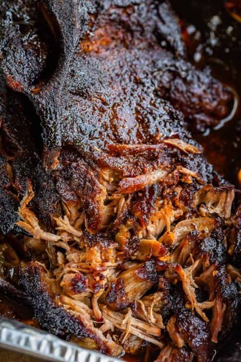 Smoked BBQ Pulled Pork (on a Gas Grill) from The Food Charlatan. This AMAZINGLY juicy and tender Smoked BBQ Pulled Pork is made on a GAS grill! Get that unique smoky flavor you love without investing in an actual smoker. It's an easy recipe that is pretty hands-off. The flavor is legit. The meat just falls apart, and you get that crispy blackened edge that only comes from outdoor cooking! This recipe is perfect for Father's Day, Game day, summer barbecues, or anytime you need to feed a crowd! Smoked Pork On Gas Grill, Pulled Pork On The Grill, Smoked Dinner, Grilled Pulled Pork, Grilled Recipes, Smoked Bbq, The Food Charlatan, Smoked Pulled Pork, Smoked Meats