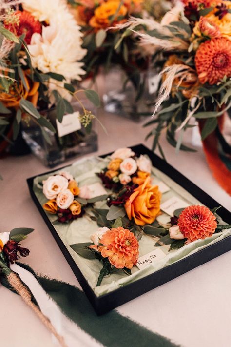 Orange dahlia and rose buttonholes for the wedding with autumnal colour palette for September wedding Autumnal Wedding Buttonholes, Dahlia Buttonhole, Wedding Wine Box Ceremony, Orange Wedding Theme, Wine Box Ceremony, Wine Box Wedding, Orange Wedding Themes, Black Wedding Shoes, Orange Dahlia