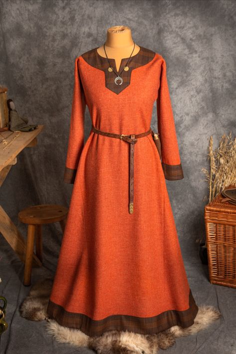 The dress has simple medieval cut with long sleeves, loose and comfortable. | #vikings #viking #vikingstyle #vikinglife #vikingreenactors #vikingreenactment #vikinghair #vikingwoman #vikingsofinstagram #vikingpride #vikinggirl #vikingwarrior #slavicgirl #slavicmythology #reenactment #reenactor #reenacting #reenactors #medieval #earlymedieval #vikingembroidery #historicalsewing #historicalcostume #aprondress #handmade Viking Dress, Viking Clothing, Dress Trims, Early Medieval, Viking Woman, Medieval Clothing, Wool Clothing, Medieval Dress, Apron Dress