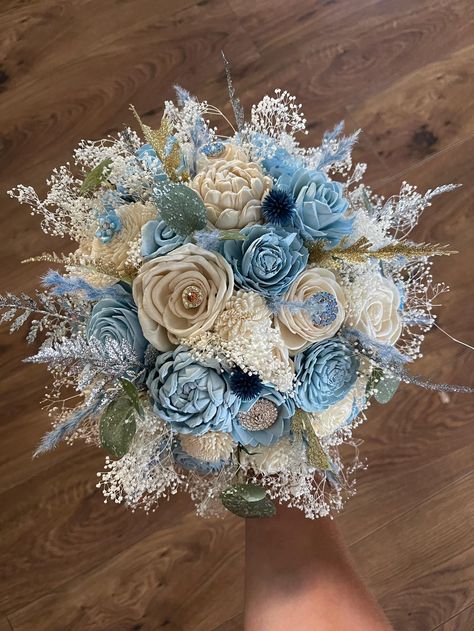 Sola wood flower quinceañera bouquet in baby blue. Greenery is a mixture of artificial and preserved . Pictured is the size medium 10". Can also be made in small and large. Can also add matching bridesmaid bouquets, corsages and boutonnieres per request. Made to order! Each flower is hand made and painted so a slight variation in placement may occur from one bouquet to the next.Can also be made in different colors. Please message me for custom quotes. Please allow 8-10 weeks for shipping. For ma Blue Quinceanera Flowers, Baby Blue Wedding Bouquet, Baby Blue Wedding Flowers, Light Blue Bouquet Quinceanera, Light Blue Flower Bouquet Prom, Quince Flower Bouquets Blue, Quinceanera Flowers, Blue Wooden Flower Bouquet, Baby Blue Quinceanera