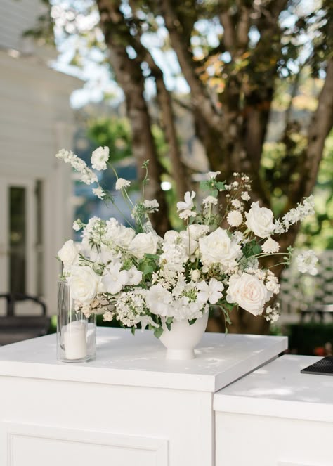 White Bar Arrangement, Bar Arrangement Wedding, Flowers On Bar Wedding, Wedding Bar Floral Arrangements, Long Table White Flowers, Organic White Wedding Florals, Wedding Bar Flowers White, Elevated Floral Centerpieces White, Sweetheart Table Flowers