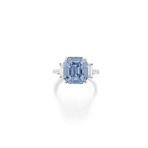 Exquisite Fancy Vivid Blue Diamond and Diamond Ring Set with an emerald-cut Fancy Vivid Blue diamond weighing 5.69 carats, flanked by baguette diamonds, size 5¼. Natural Blue Diamond, Haute Jewelry, Colored Diamond Jewelry, Diamond Bracelet Design, Blue Diamond Ring, International Jewelry, Baguette Diamonds, Diamond Ring Settings, Bling Rings