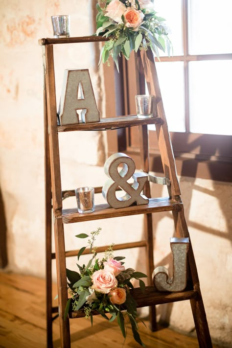 Darling rustic indoor wedding decor. Love the wooden step ladder, tin initials, and pops of blush through the blush roses. And to add some elegance, some candles! Taken at THE SPRINGS Event Venue in Anna, TX. Book your free tour today! Photographer: Cortney Dani Photography Rustic Wedding Decorations, Wedding Venues Indoor, Simple Wedding Centerpieces, Summer Wedding Decorations, Wooden Ladder, Have Inspiration, Vintage Wedding Decorations, Indoor Wedding, Anniversary Party