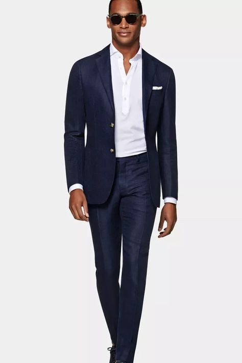 At first glance, this looks like any other navy blue wedding suit. But when you look closer, you see a nice texture that makes this one feel and look extra special. Take notes from the styling and pair with sunglasses for an extra cool modern spring wedding look. Here are more classic wedding suits perfect for spring. // Photo: Suit Supply Suit Supply Mens Fashion, Colorful Wedding Suit, Navy Linen Suit, Vusi Thembekwayo, Wedding Suit Ideas, Navy Blue Suit Men, Colorful Suits, Black And Grey Suit, Mens Navy Suit